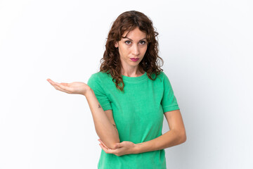 Young woman with curly hair isolated on white background having doubts