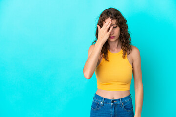 Young woman with curly hair isolated on blue background with headache