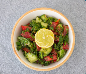 Mixed salad with lemon in a dish