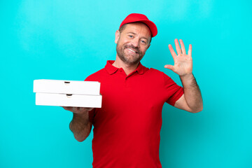 Pizza delivery man with work uniform picking up pizza boxes isolated on blue background counting...