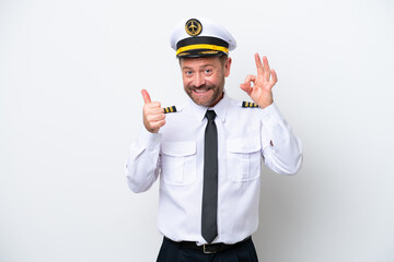 Airplane middle age pilot isolated on white background showing ok sign and thumb up gesture