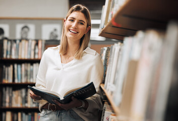 Student, reading or books in library on school, university or college campus for education, study...