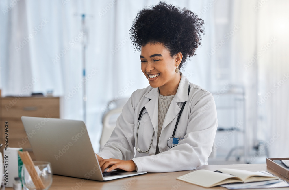 Wall mural Black woman, doctor and laptop with smile for healthcare, email or telemedicine by work desk at the hospital. African American female medical expert smiling on computer in medicare research at clinic