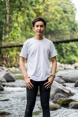 An Asian Man With White Shirt Posing Near a River in the Nature