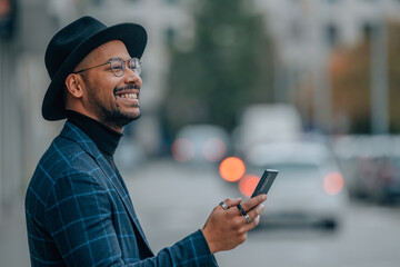 modern business man with mobile phone in the city street