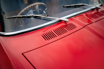 Naklejka premium Red car hood windshield and glass cleaning brushes 