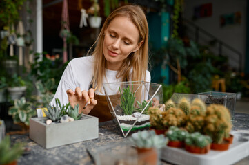 A woman making composition in florarium vase