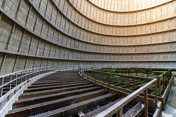 Inside a cooling tower of a nuclear power plant. Green overgrown. abandoned place
