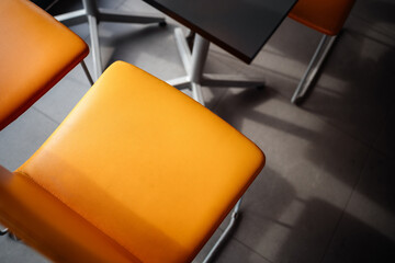 Orange chair or armchair. The texture and light in the interior are a detail of the composition.