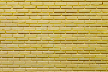 Brick wall painted in yellow for background