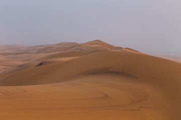 Fototapeta na wymiar Desert off the coast of the Atlantic Ocean. Beautiful sunset. Walvis Bay. Swakopmund, Namibia.