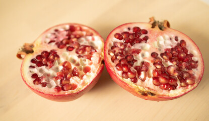 with a knife, on a wooden board. Weight loss, proper nutrition, diet, expensive fruits, pomegranate...