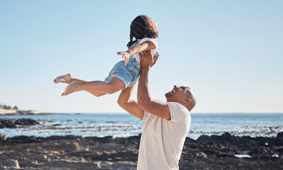 Beach, man holding girl in air and playful for vacation, summer and weekend break. Father swing...