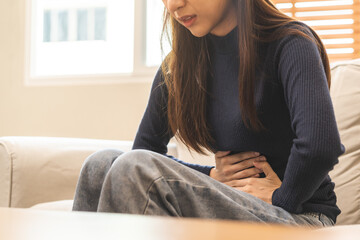 Flatulence asian young woman, girl hand in stomach ache, suffer from food poisoning, abdominal pain...