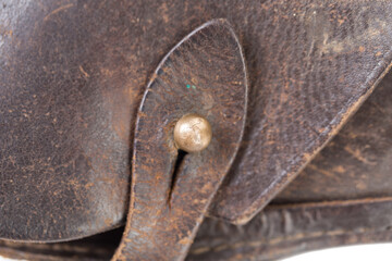 The clasp on the old leather holster.