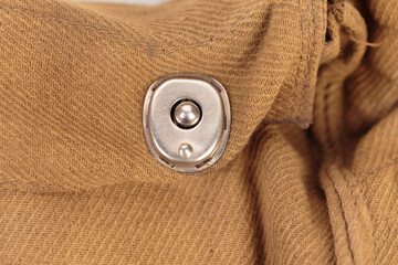 A fragment with a rivet from an old duffel.
