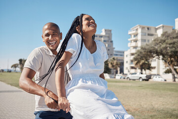 Date, bike and summer with a black couple having fun together in a park by the promenade during vacation. Cycling, laughing and comic with a man and woman tourist enjoying travel on holiday