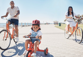Cycling, bonding and family on the promenade with a bike for summer fitness, fun and quality time...