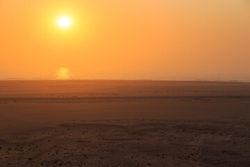 Fototapeta premium Desert off the coast of the Atlantic Ocean. Beautiful sunset. Walvis Bay. Swakopmund, Namibia.