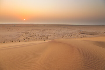 Desert off the coast of the Atlantic Ocean. Beautiful sunset. Walvis Bay. Swakopmund, Namibia.