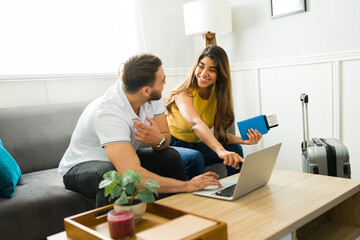 Smiling woman and man booking their vacations online