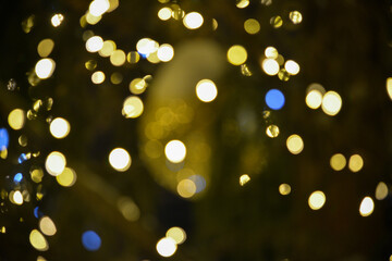 Colorful Red, Yellow and Green Christmas Tree Bokeh background of de focused glittering lights, Christmas background pattern concept.