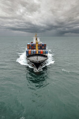 Fototapeta premium Impressive aerial wide angle view of a container ship crossing the oceans
