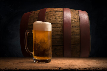 mug of beer, wheat ears, hops and beer barrel on a wooden background. High quality photo