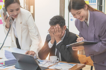 A team of three Asian businessmen is working inside an office where businessmen in black suits are being ordered by their supervisors and bosses a lot causing stress at work. burnout concept