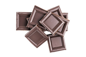 Dark chocolate pieces, cubes on a heap, broken chocolate isolated on white background, top view