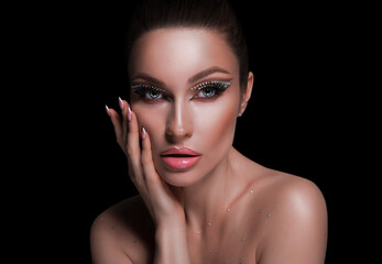 Portrait of a delightful woman in bronze toning. The concept of cosmetology, skin care, make-up, parties, beautiful faces.