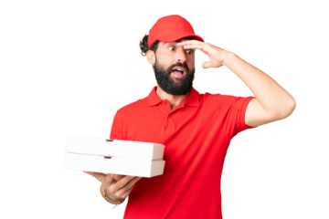 Pizza delivery man with work uniform picking up pizza boxes over isolated chroma key background doing surprise gesture while looking to the side