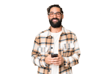 Young man with beard over isolated chroma key background sending a message with the mobile