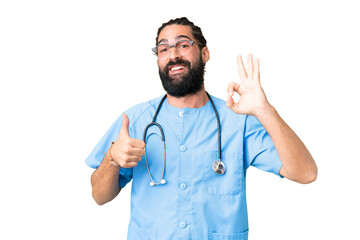 Young doctor man over isolated chroma key background showing ok sign and thumb up gesture