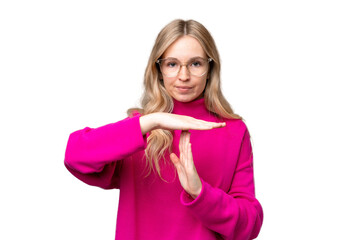 Young English woman over isolated background making time out gesture