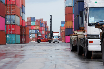 Semi-trucks and container lifters in the container yard