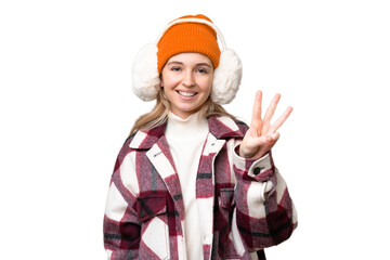 Young  English woman wearing winter muffs over isolated background happy and counting three with fingers