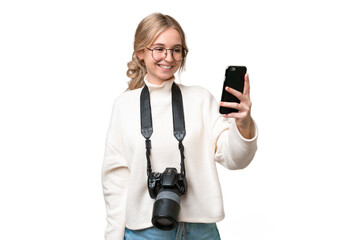 Young photographer English woman over isolated background making a selfie