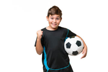 Little caucasian football player kid over isolated chroma key background celebrating a victory in winner position
