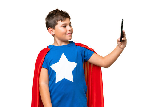 Super Hero caucasian kid over isolated chroma key background making a selfie