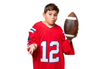 Little caucasian kid playing rugby over isolated chroma key background making doubts gesture while lifting the shoulders