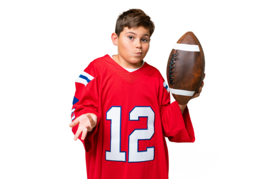 Little caucasian kid playing rugby over isolated chroma key background making doubts gesture while lifting the shoulders