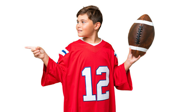 Little caucasian kid playing rugby over isolated chroma key background pointing to the side to present a product - Powered by Adobe