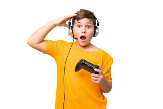 Little caucasian kid playing with a video game controller over isolated chroma key background with surprise expression