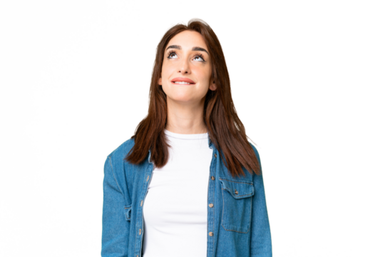 Young caucasian woman over isolated chroma key background and looking up