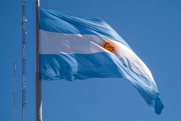 Argentine flag waving high in a cloudless sky