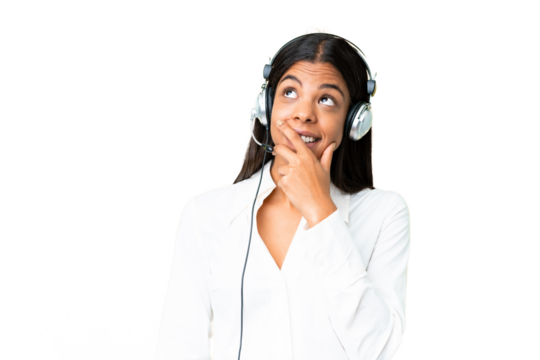 Telemarketer African American woman working with a headset over isolated chroma key background having doubts and with confuse face expression