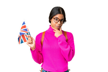 Young African American woman holding an United Kingdom flag over isolated chroma key background thinking