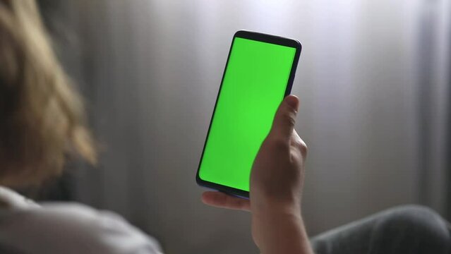 hands holding green screen phone	