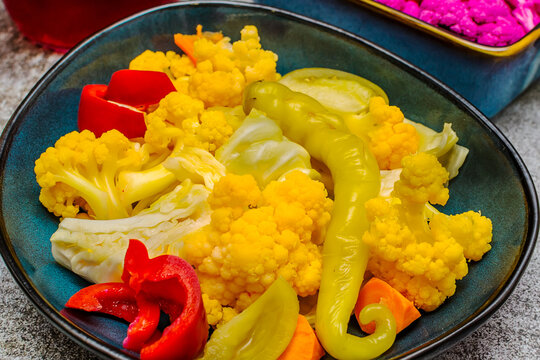Homemade pickle with yellow and purple cauliflower